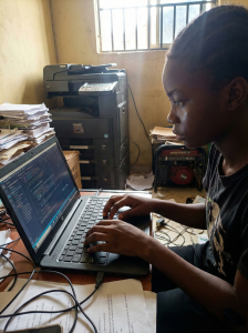 A determined female student in Wakiso intensely focused on advanced studies during Day of the African Child commemorations at Fecane Child Foundation.